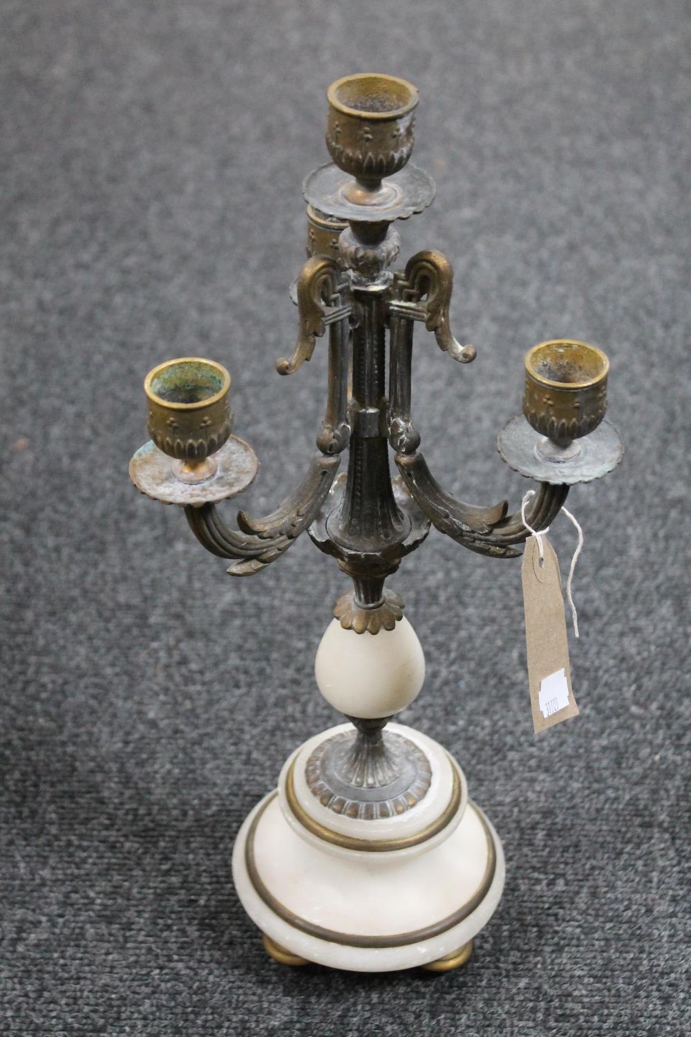A brass and alabaster four way table candelabra