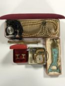 A box of costume jewellery to include Russian wrist watch face, Queen Star lighter, cufflinks,