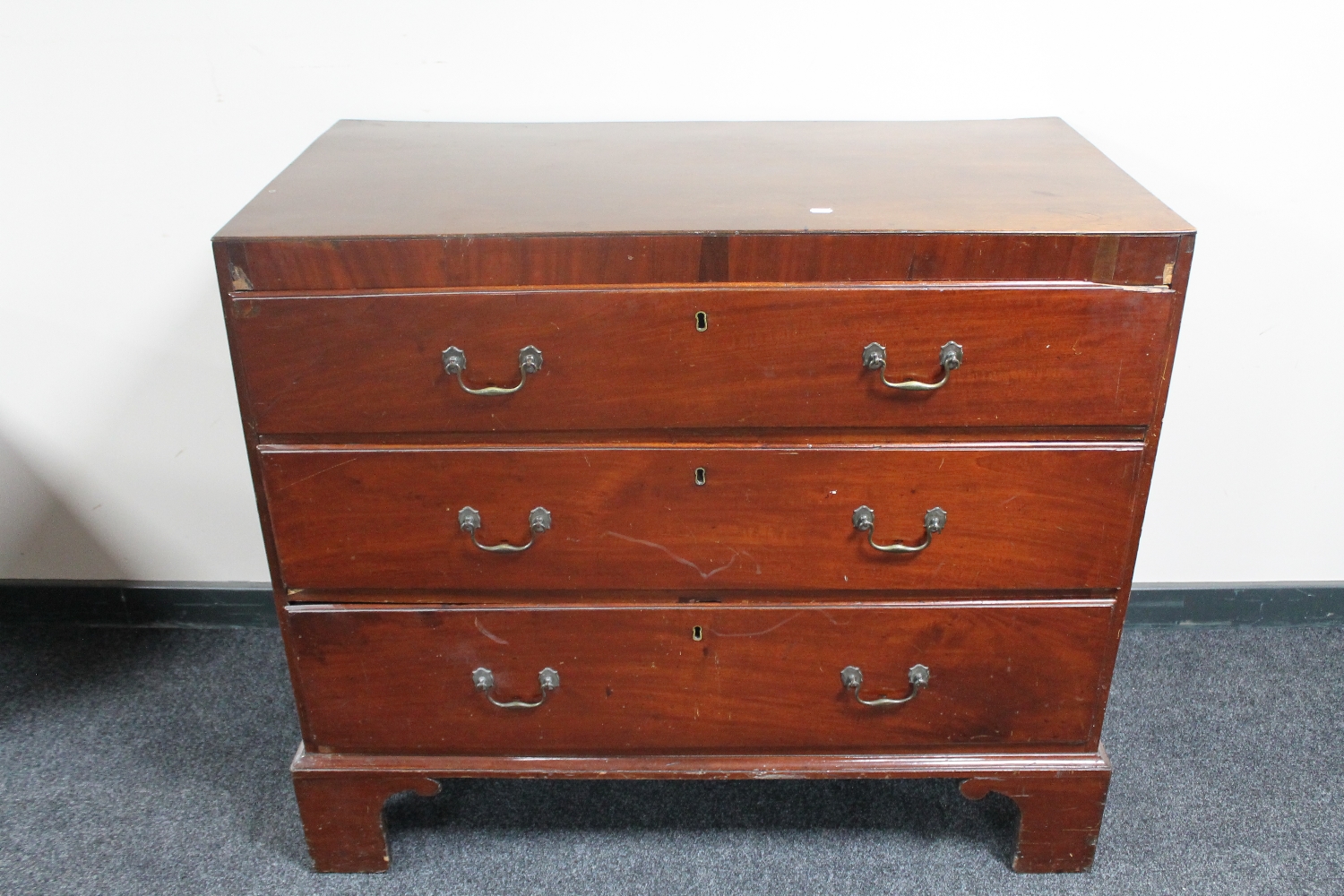 A Victorian mahogany three drawer chest (one foot needs attention)