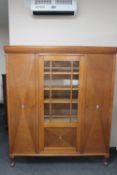 A continental oak triple door cabinet with mother of pearl inlay