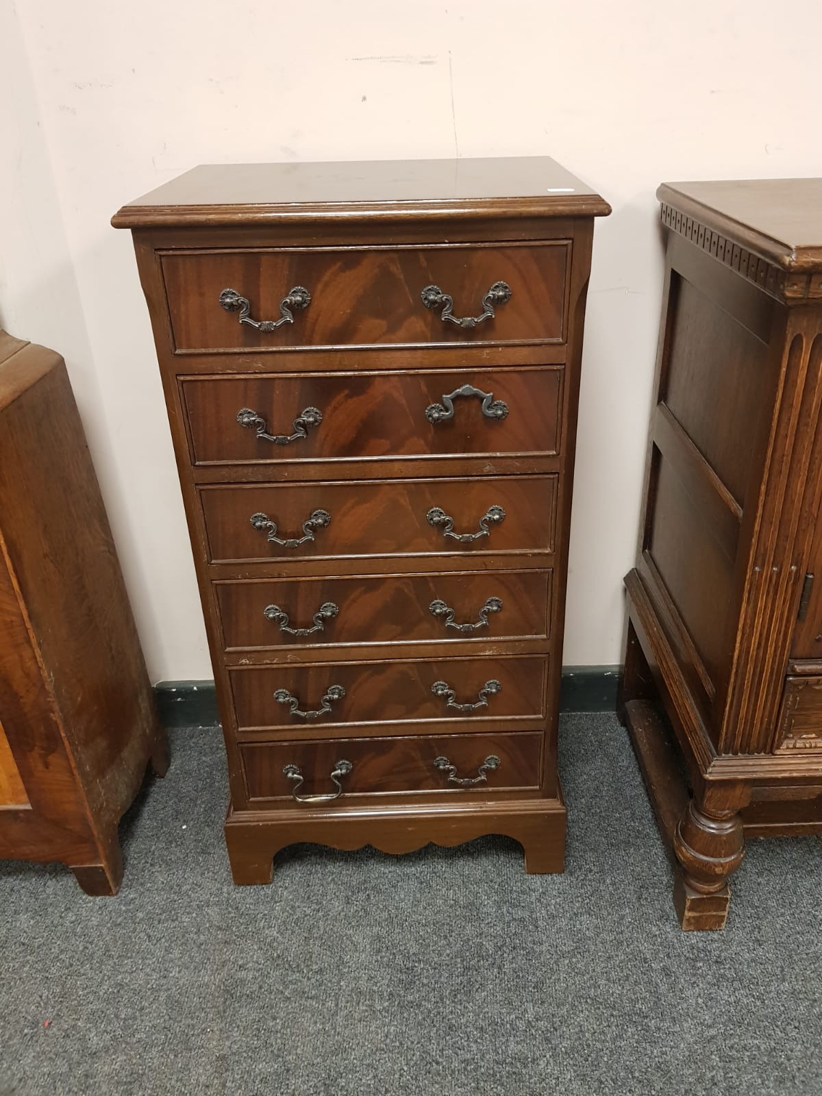 A reproduction mahogany six drawer chest,