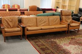 A three piece mid twentieth century brown leather lounge suite