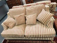A three seater and two seater classical style settees and footstool by Wade,