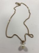 A 9ct gold necklace with pearl drop pendant, 5.1g gross.