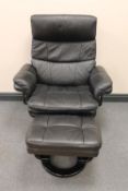 A late twentieth century black leather swivel adjustable armchair with stool