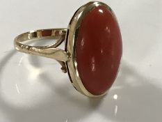 A yellow gold coral ring, 4.6g, size N/O. CONDITION REPORT: Hallmarks rubbed.