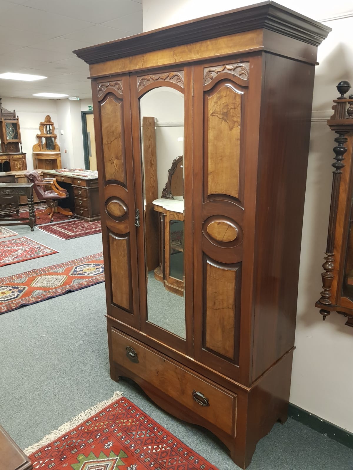 An Edwardian walnut single door wardrobe.