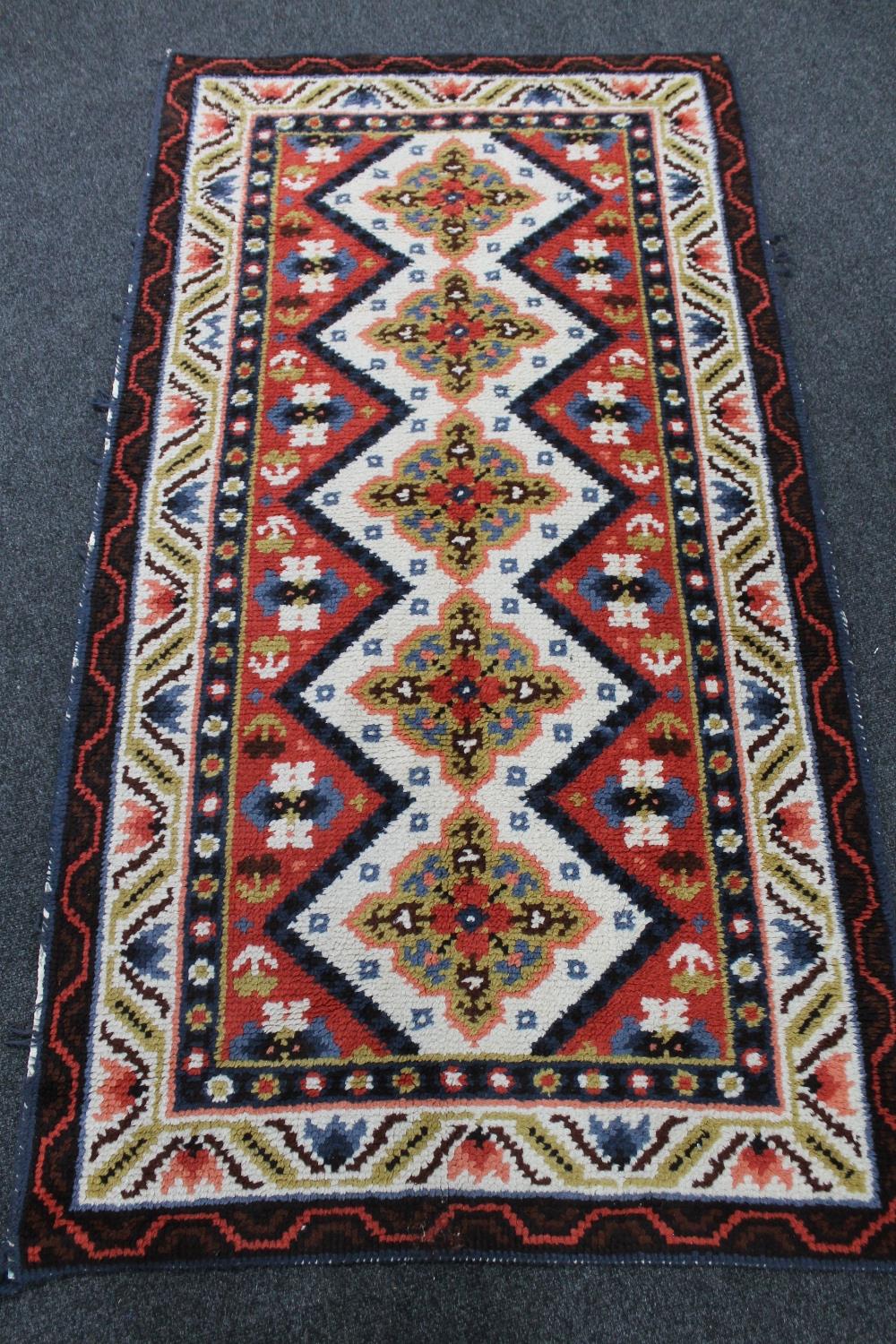 An Eastern woollen rug 194 cm x 105 cm