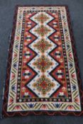 An Eastern woollen rug 194 cm x 105 cm