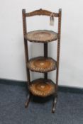 An Eastern inlaid three tier folding cake stand