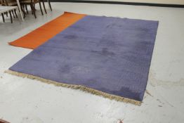 Blue fringed embossed rug and an orange rug