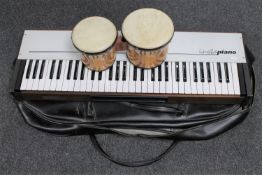 An Insta piano in carry bag together with a set of hand drums