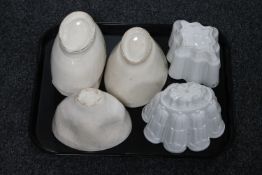 A tray containing two antique Shelley jelly moulds together with four further pottery jelly moulds