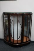 A 1930's walnut shaped display cabinet