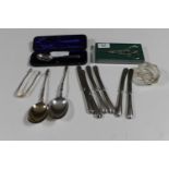 A tray of cased silver spoon, silver sugar tongs, pair of silver apostle spoons,