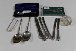 A tray of cased silver spoon, silver sugar tongs, pair of silver apostle spoons,