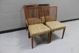 Four Danish teak spindle back dining chairs