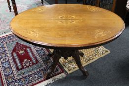 A Victorian inlaid mahogany oval pedestal tea table