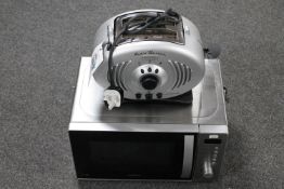 A Kenwood microwave together with a Delonghi two slice radio toaster