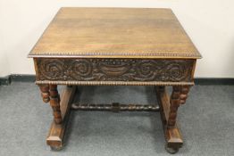 An early 20th century carved oak centre table,