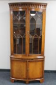 A mahogany Regency style double door corner display cabinet