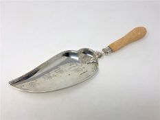 A fine quality ornate Edwardian silver crumb scoop with ivory handle