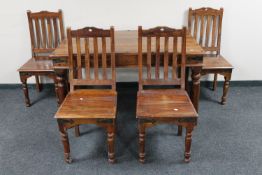 A sheesham wood dining table together with four rail back chairs