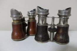 Two pairs of antique leather bound field glasses