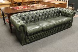 A green leather four seater Chesterfield club settee,