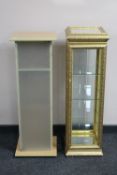 A gilt and glass narrow curio cabinet with mirrored top and a beech effect media cabinet