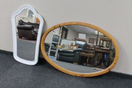 A large pine oval framed mirror together with a painted framed mirror