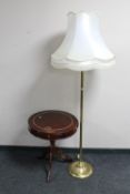 A mahogany pedestal drum table and a brass standard lamp