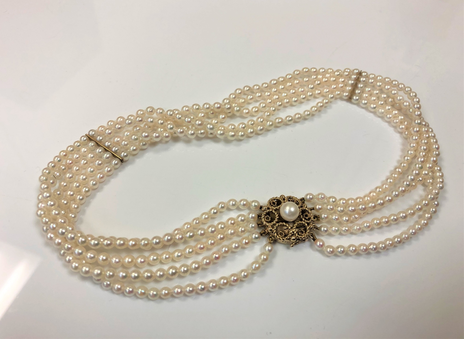 A cultured pearl five stranded collar on 9ct gold clasp,