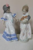Two Lladro figures of a girl in traditional Spanish dress with oranges and Spanish dancer