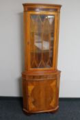 A yew wood corner display cabinet