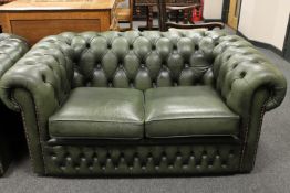 A green leather two seater Chesterfield club settee,