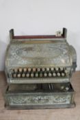 An antique brass National cash register
