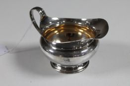 A silver cream jug,