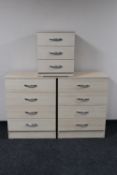 A pair of contemporary four drawer chests and matching three drawer chest in pine finish
