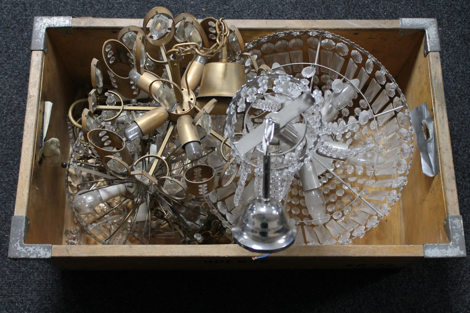 A crate containing three assorted light fittings with glass drops
