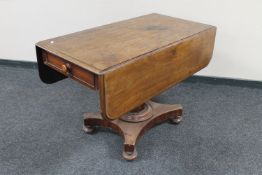 A Victorian mahogany drop leaf pedestal dining table fitted a drawer