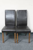 A pair of brown leather high back dining chairs