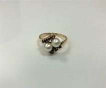 A 9ct gold ring set with two pearls and six small garnets, 3.6g, size O.