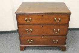 A George III mahogany three drawer chest on bracket feet,