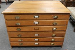 A early 20th century oak six drawer plan chest,