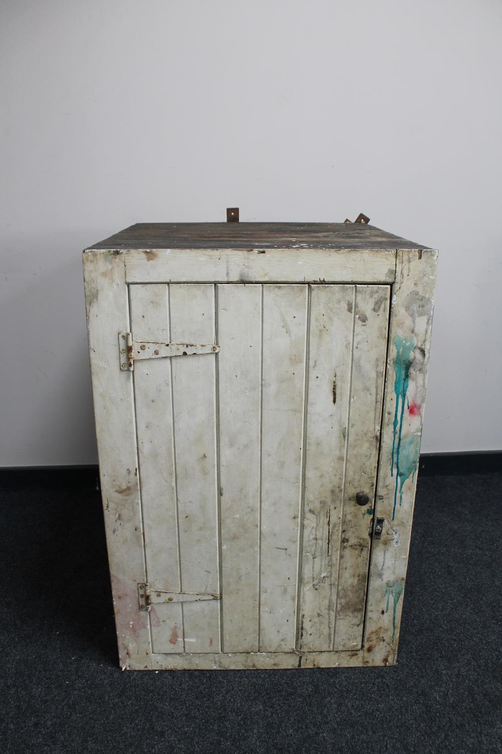 An antique pitch pine painted single door cabinet