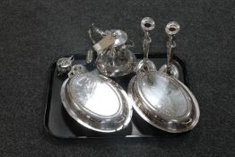 A tray containing plated wares to include two entree dishes with covers, teapot,