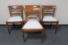 A set of four contemporary mahogany dining chairs
