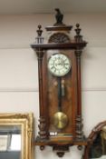 A Victorian enamelled dial wall clock with pendulum and two weights,