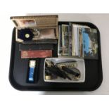 A tray containing lady's and gent's wristwatches, costume jewellery, postcards,